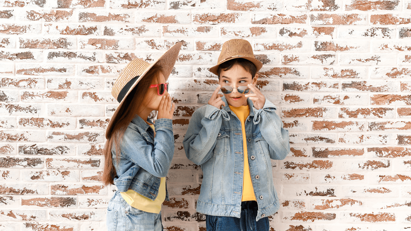 kids wearing hats and whispering to each other