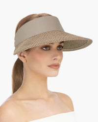 Woman wearing a wide-brimmed visor against a white background., eric jarvis hat, visor hats