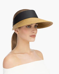 Woman wearing a straw visor with a black band., eric jarvis hat, eric javits champ