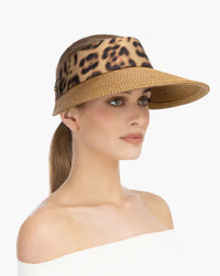 Woman wearing a leopard-print visor hat with a woven brim., eric jarvis hat, visirs