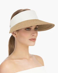 Woman wearing a beige sun visor with white trim, side profile view., visirs, eric javits champ